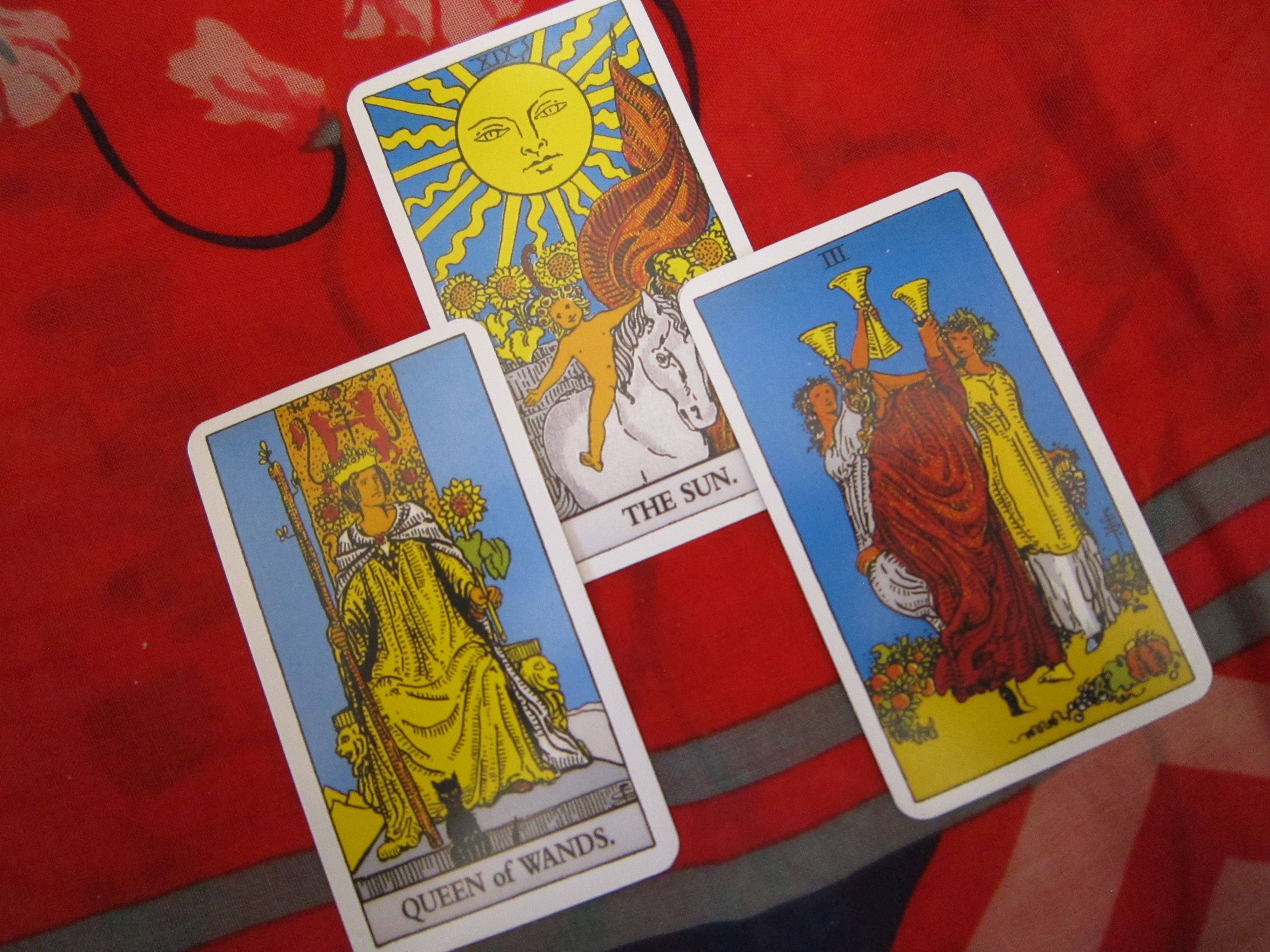 Three tarot cards displayed during a tarot reading.